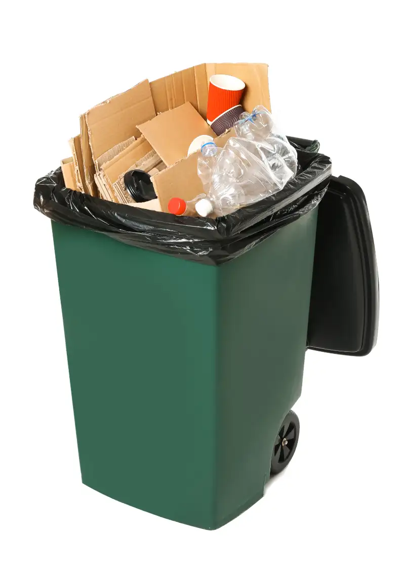 overflowing green recycling bin cardboard plastic